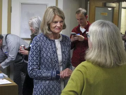 Alaska U.S. Sen. Lisa Murkowski, center, is shown at the grand opening of her reelection campaign office in Juneau, Alaska, on Thursday, Aug. 11, 2022. Murkowski said she expects to be among the candidates who will advance from the Aug. 16, 2022, U.S. Senate primary in Alaska. Under a system approved by voters and being used in Alaska for the first time this year, the top four vote-getters in the primary, regardless of party affiliation, will advance to the November general election, in which ra