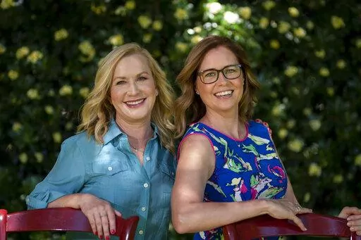 Angela Kinsey, left, and Jenna Fischer, friends and former co-stars of the comedy series "The Office" pose for photos in Glendale, Calif., Tuesday, March 22, 2022, to promote their book "The Office BFFs: Tales of The Office from Two Best Friends Who Were There." (AP Photo/Jae C. Hong)