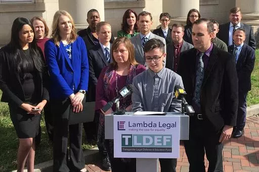 Connor Thonen-Fleck addresses reporters while his parents stand by his side, March 11, 2019, in Durham, N.C. West Virginia and North Carolina's refusal to cover certain health care for transgender people with government-sponsored insurance is discriminatory, a federal appeals court ruled Monday, April 29, 2024 in a case likely headed to the U.S. Supreme Court. (AP Photo/ Jonathan Drew, FIle)