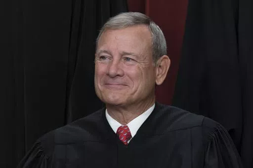 Chief Justice of the United States John Roberts joins other members of the Supreme Court as they pose for a new group portrait, at the Supreme Court building in Washington, Oct. 7, 2022. Roberts has declined an invitation to meet with Democratic senators to talk about Supreme Court ethics and the controversy over flags that flew outside homes owned by Justice Samuel Alito. (AP Photo/J. Scott Applewhite, File)