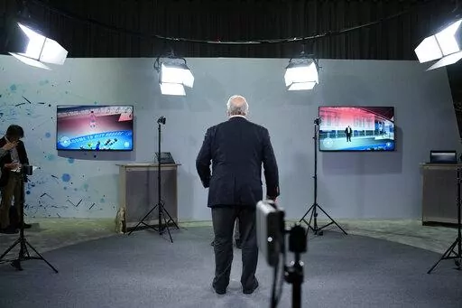 An attendee stands between cameras used to live broadcast into the metaverse during a Sony news conference before the start of the CES tech show Wednesday, Jan. 4, 2023, in Las Vegas. (AP Photo/John Locher)