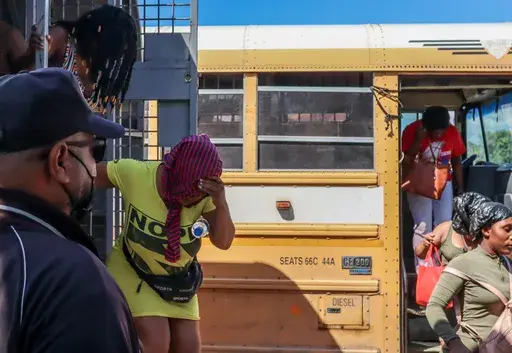 Haitians deported from the Dominican Republic get out of trucks in Carrizal, Dominican Republic, on the border with Haiti, Thursday, Jan. 30, 2025. (AP Photo/Martin Adames)