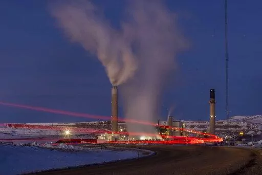 Taillights trace the path of a motor vehicle at the Naughton Power Plant, Jan. 13, 2022, in Kemmerer, Wyo. The Supreme Court decision June 30, restricting the authority of the Environmental Protection Agency may mean continued pollution from power plants in states that are not switching to cleaner energy. But many states are switching and experts say they'll remain free to keep cleaning up their electrical grids under the new decision. (AP Photo/Natalie Behring, File)