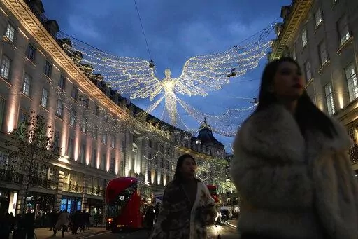 People walk on Regent Street, in London, on Nov. 17, 2022. Britain’s economy shrank in the three months through October, confirming the toll that rampant inflation and rising interest rates are having on business and industry. (AP Photo/Kin Cheung, File)