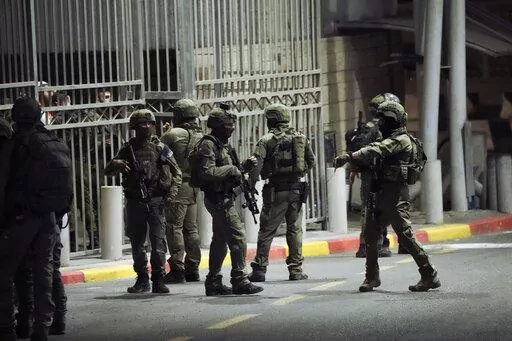 Israeli security forces patrol next to the scene of a shooting attack near the Shuafat refugee camp in Jerusalem, Saturday, Oct. 8, 2022. Israeli police say armed assailants have opened fire at an Israeli military checkpoint in east Jerusalem, seriously wounding at least two people. (AP Photo/Mahmoud Illean)