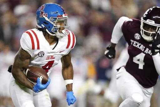 Mississippi running back Quinshon Judkins (4) looks to turn the corner against Texas A&M defensive lineman Shemar Stewart (4) during the first half of an NCAA college football game Saturday, Oct. 29, 2022, in College Station, Texas. (AP Photo/Sam Craft)