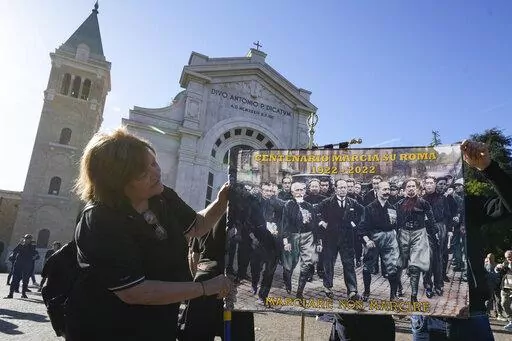People march in the hometown of former dictator Benito Mussolini to mark the 100th anniversary of the coup d'etat by which he sized power in 1922, in Predappio, Italy, Sunday, Oct. 30, 2022. (AP Photo/Luca Bruno)