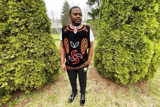 Wilfred Tebah, who fled Cameroon during its ongoing conflict, poses for a photo in the backyard of his home, Thursday, March 31, 2022, in Columbus, Ohio. African refugees say the recent decision to grant Ukrainians fleeing war refugee status and other humanitarian protections underscores the racial bias inherent in American immigration policy. Tebah says he and other immigrants from Cameroon have long been deserving of similar humanitarian considerations. (AP Photo/Patrick Orsagos)