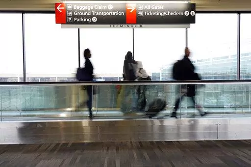 FILE - Travelers walk to their gates at the Philadelphia International Airport on Friday, Dec. 31, 2021, in Philadelphia. Wintry weather combined with the pandemic to frustrate air travelers whose return flights home from the holidays were canceled or delayed in the first days of the new year. (AP Photo/Michael Perez)