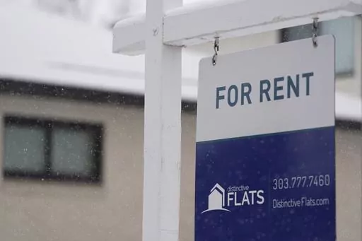 A for rent sign stands outside a single-family home on the market Saturday, Feb. 10, 2024, in Denver. A record number of Americans who rent are now considered cost-burdened, with 30% or more of their income going toward rent and utilities. Companies like Flex, which let you divide your rent into smaller installments via a line of credit or loan, say they’re part of the solution. (AP Photo/David Zalubowski, File)