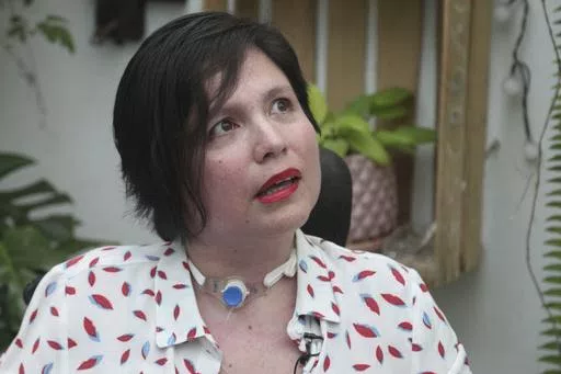 Ana Estrada, a Peruvian psychologist who is almost completely paralyzed by a terminal illness, gives an interview at her home in Lima, Peru, Dec. 18, 2019. Estrada, who was authorized in 2022 by Peru's Supreme Court to receive euthanasia, has died, her lawyer said Monday, April 22, 2024. (AP Photo/Martin Mejia, File)