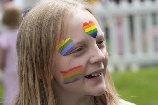 Bonneville Elementary School 5th grader Graham Beeton, is interviewed during a block party supporting trans and non binary students and staff Monday, April 29, 2024, in Salt Lake City. Utah will become the latest state to implement restrictions for transgender people using school bathrooms and locker rooms in public schools and government-owned buildings when key components of a law passed by the Republican controlled Legislature take effect May 1. (AP Photo/Rick Bowmer)