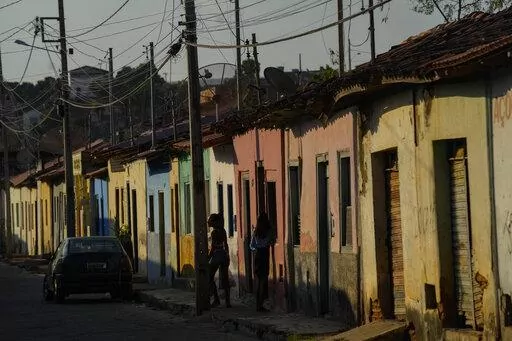 Residents stand on the sidewalk in Aracuai, Brazil, Oct. 11, 2022. Araçuai is part of the Jequitinhonha Valley in northern Minas Gerais state, bordering the poor northeast region that is a stronghold for former President Luiz Inacio Lula da Silva, who is running for president again. Gaining traction in Minas Gerais is especially important to incumbent Jair Bolsonaro, as the state has the second-largest population in the country. The two presidential candidates will face each other in a runoff O