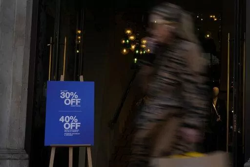 A woman passes by a clothing chain advertising a sale on Regent Street in London, Wednesday, Nov. 16, 2022. Britain's inflation rate rose to a 41-year high in October, fueling demands for the government to do more to ease the nation's cost-of-living crisis when it releases new tax and spending plans on Thursday. The Office for National Statistics says consumer prices rose 11.1% in the 12 months through October, compared with 10.1% in September. The October figure exceeded economists expectations