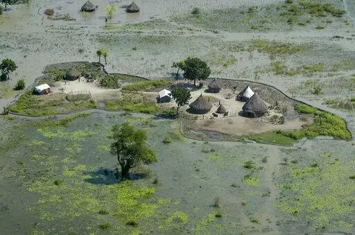 Thatched huts surrounded by floodwaters are seen from the air in Old Fangak county, Jonglei state, South Sudan, Nov. 27, 2020. South Sudan's President Salva Kiir Mayardit ordered the suspension Saturday, July 9, of all dredging-related activities in the country until evidence-based studies are carried out on their on surrounding communities and the ecosystems they rely on. (AP Photo/Maura Ajak, File)