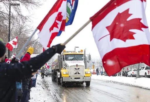 People gather in protest against COVID-19 mandates and in support of a protest against COVID-19 restrictions taking place in Ottawa, in Edmonton, Alberta, Saturday, Feb. 5, 2022. (Jason Franson/The Canadian Press via AP)