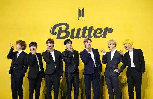 FILE- Members of South Korean K-pop band BTS, V, SUGA, JIN, Jung Kook, RM, Jimin, and j-hope from left to right, pose for photographers ahead of a press conference to introduce their new single "Butter" in Seoul, South Korea, May 21, 2021. The members of K-pop band BTS will serve their mandatory military duties under South Korean law, their management company said Monday, Oct. 17, 2022, effectively ending a debate on exempting them because of their artistic accomplishments. (AP Photo/Lee Jin-man