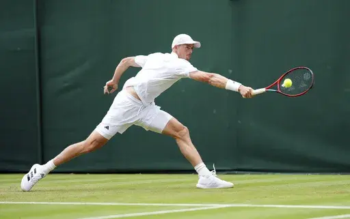 Britain's Billy Harris returns a shot to Spain's Jaume Munar during their men's singles first round tennis match on day two of the Wimbledon tennis championships in London, Tuesday, July 2, 2024. (John Walton/PA via AP)