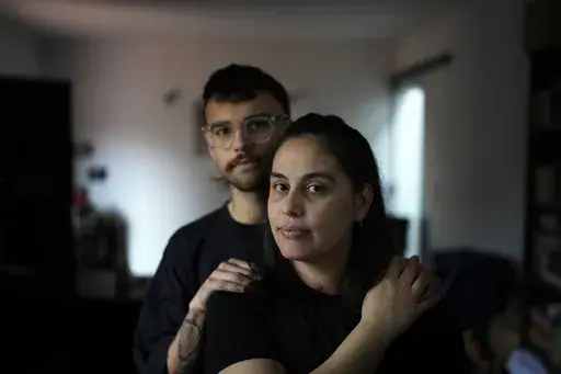 Diana Zalazar and her son Ato Martino pose for a portrait at their home in Asuncion, Paraguay, Friday, Aug. 23, 2024. Zalazar said she got pregnant after having sex with her first partner when she was 14 years old but that no one had talked to her about the risks of pregnancy or sexually transmitted diseases. (AP Photo/Jorge Saenz)