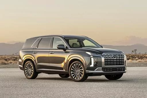 This photo provided by Hyundai shows the 2023 Hyundai Palisade a midsize three-row SUV. Both the Palisade and its corporate cousin, the Kia Telluride, are top picks in this class. (Courtesy of Hyundai Motor America via AP)