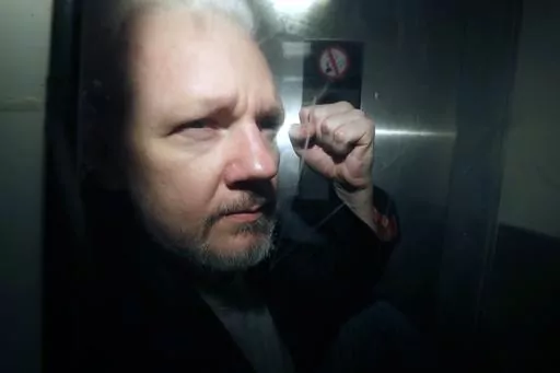 WikiLeaks founder Julian Assange being taken from court, where he appeared on charges of jumping British bail seven years ago, in London, Wednesday May 1, 2019. A London court is due to rule whether WikiLeaks founder Julian Assange can challenge extradition to the United States on espionage charges. Two judges will issue a ruling Tuesday morning in the High Court on whether Assange can make one final appeal in England. (AP Photo/Matt Dunham, File)
