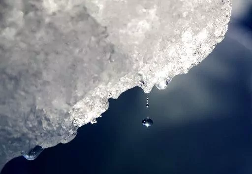 A drop of water falls off an iceberg melting in the Nuup Kangerlua Fjord near Nuuk in southwestern Greenland, Tuesday, Aug. 1, 2017. Earth’s poles are undergoing simultaneous freakish extreme heat with parts of Antarctica more than 70 degrees (40 degrees Celsius) warmer than average and areas of the Arctic more than 50 degrees (30 degrees Celsius) warmer than average. (AP Photo/David Goldman, File)