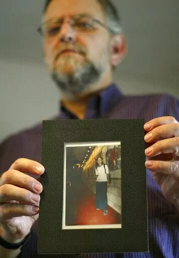 Arnold Roth holds a photo of his 15-year-old daughter Malki, who was killed in an August 2001 Palestinian suicide bombing at a Jerusalem pizzeria, at his house in Jerusalem, on Sept. 28, 2004. The family of an Israel-American girl killed in a 2001 Palestinian suicide bombing in Jerusalem is seeking a meeting with President Joe Biden in hopes of forcing Jordan to extradite Tamimi, who was convicted in the deadly attack. The parents of Malki Roth sent a letter to the White House on Sunday, July 10