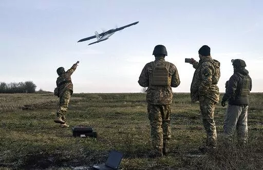 Ukrainian soldiers launch a drone at Russian positions near Bakhmut, Donetsk region, Ukraine, Thursday, Dec. 15, 2022. (AP Photo/LIBKOS)