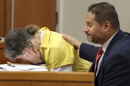 Defendant Susan Lorincz, left, who fatally shot a Black neighbor through her front door during an ongoing dispute, weeps during her sentencing hearing Monday, Nov. 25, 2024, in Ocala, Fla. (Bruce Ackerman/Ocala Gazette via AP, Pool)