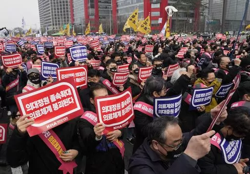 Doctors stage a rally against the government's medical policy in Seoul, South Korea, on March 3, 2024. South Korean authorities have suspended the licenses of two senior doctors for allegedly inciting the weekslong walkouts by medical interns and residents that disrupted hospital operations across the country. That's according to one of the doctors who spoke to The Associated Press. The suspensions are the government’s first punitive step against physicians after thousands of doctors-in-traini