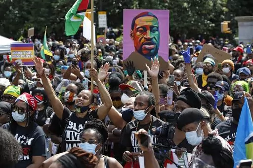People participate in a Caribbean-led Black Lives Matter rally on June 14, 2020, at Brooklyn's Grand Army Plaza in New York. On Wednesday, July 19, 2023, New York City agreed to pay more than $13 million to settle a civil rights lawsuit brought on behalf of roughly 1,300 people who were arrested or beaten by police during racial injustice demonstrations that swept through the city during the summer of 2020. (AP Photo/Kathy Willen, File)