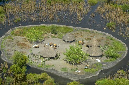 Thatched huts surrounded by floodwaters are seen from the air in Old Fangak county in Jonglei state, South Sudan on Nov. 27, 2020. A petition to stop the revival of the 118-year-old Jonglei Canal project in South Sudan, started by one of the country's top academics, is gaining traction in the country, with the waterway touted as a catastrophic environmental and social disaster for the country's Sudd wetlands. (AP Photo/Maura Ajak, File)