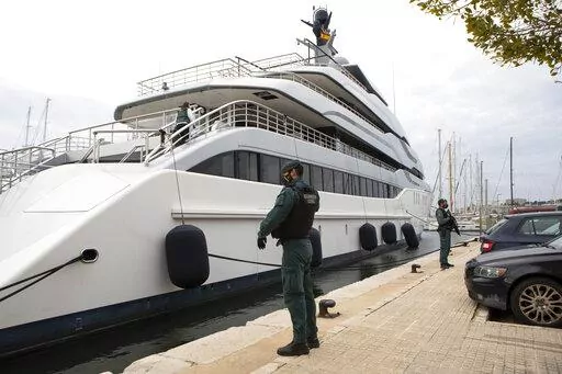 Civil Guards stand by the yacht called Tango in Palma de Mallorca, Spain, Monday April 4, 2022. U.S. federal agents and Spain's Civil Guard are searching the yacht owned by a Russian oligarch.  The United States and allies are again escalating sanctions against Russia, Wednesday, April 6, after evidence that Russian troops murdered Ukrainian civilians in a town near Kyiv.  (AP Photo/Francisco Ubilla, File)