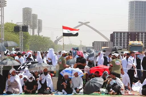 Followers of Shiite cleric Muqtada al-Sadr gather during an open-air Friday prayers at Grand Festivities Square within the Green Zone, in Baghdad, Iraq, Friday, Aug. 5, 2022. (AP Photo/Anmar Khalil)