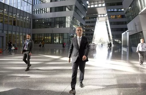 NATO Secretary General Jens Stoltenberg, center, walks in the Agora Hall as he arrives for his first day of work at the new NATO headquarters in Brussels on May 7, 2018. NATO Secretary General Jens Stoltenberg, the top civilian official at the world's biggest security alliance, routinely praises allies for helping Ukraine's troops to fight back. But when he does, Stoltenberg is talking about individual member countries, not NATO as an organization. (AP Photo/Virginia Mayo, File)