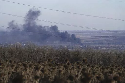 Smoke billows during fighting between Ukrainian and Russian forces in Soledar, Donetsk region, Ukraine, Wednesday, Jan. 11, 2023. Soledar and Bakhmut again highlighted a bitter rift between the top military brass and Yevgeny Prigozhin, a rogue millionaire whose Wagner Group military contractor has played an increasing role in Ukraine. (AP Photo/Libkos, File)