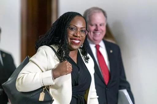 Supreme Court nominee Ketanji Brown Jackson smiles as she arrives for a meeting with Sen. Ben Sasse, R-Neb., a member of the Judiciary Committee, at the Capitol in Washington, March 3, 2022. Former Alabama Sen. Doug Jones has guided Jackson through the process of courting senators and preparing for her confirmation hearing that opens Monday. (AP Photo/J. Scott Applewhite, File)