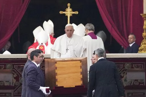 Pope Francis, centre, sits as the coffin of late Pope Emeritus Benedict XVI St. Peter's Square is carrying during a funeral mass at the Vatican, Thursday, Jan. 5, 2023. Benedict died at 95 on Dec. 31 in the monastery on the Vatican grounds where he had spent nearly all of his decade in retirement. (AP Photo/Alessandra Tarantino)