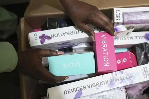 A woman shows a selection of sex toys she sells to women in Zimbabwe, on Friday, June, 23, 2023. Zimbabwean woman Sitabile Dewa is challenging a sex toys ban in the country which she describes in court papers filed in March as "archaic" and "repressive" laws used to arrest women for having sex toys. Her court challenge - a bold act in a society where females are usually shamed for being openly sexual - highlights the struggles endured by Zimbabwean women battling to attain sexual freedom. (AP Ph