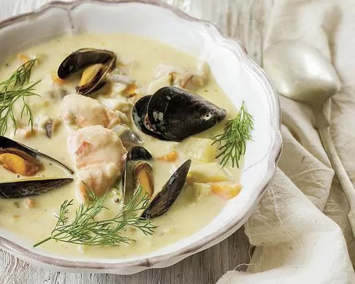 This image shows a recipe for creamy seafood chowder, from Imen McDonnell's “The Farmette Cookbook: Recipes and Adventures from My Life on an Irish Farm.” (Imen McDonnell via AP)