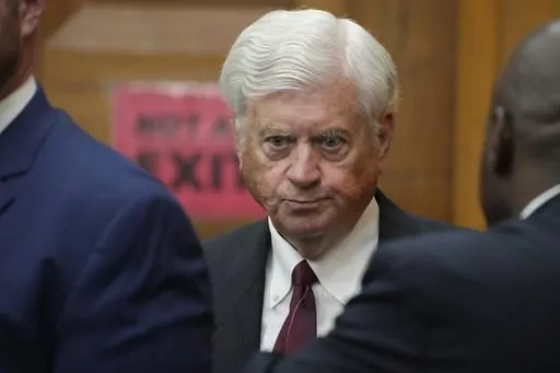 Mississippi Supreme Court Chief Justice Mike Randolph confers with his attorneys on May 10, 2023, in Hinds County Chancery Court in Jackson, Miss., where a judge heard arguments about a Mississippi law that would create a court system with judges who would be appointed rather than elected. The chancery judge removed Randolph as a defendant and dismissed the lawsuit. Randolph has recused himself from hearing an appeal on Thursday, July 6, 2023, as the plaintiffs ask the state Supreme Court to rev