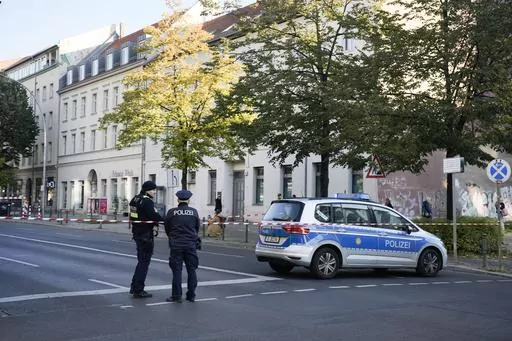 German police officers stand guard in front of the building complex of the Kahal Adass Jisroel community, which houses a synagogue, a kindergarten and a community center, in the center of Berlin, Germany, Wednesday, Oct. 18, 2023. European Union interior ministers met Thursday, Oct. 19, 2023, to discuss how to manage the impact of the war between Israel and Hamas on the bloc, after a firebomb assault on a Berlin synagogue and killings in Belgium and France by suspected Islamist extremists. (AP P