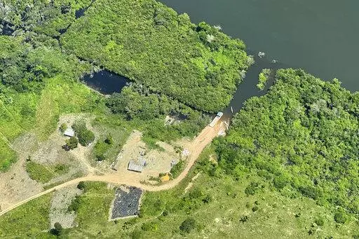 This May 2, 2022, photo provided by Xingu + Network shows an illegal road inside a protected area called Terra do Meio (Middle Earth) Ecological Station in Para state, in the Brazilian Amazon. The dirt road is now just a few miles shy of connecting two of the worst areas of deforestation in the region. (Xingu + Network via AP)