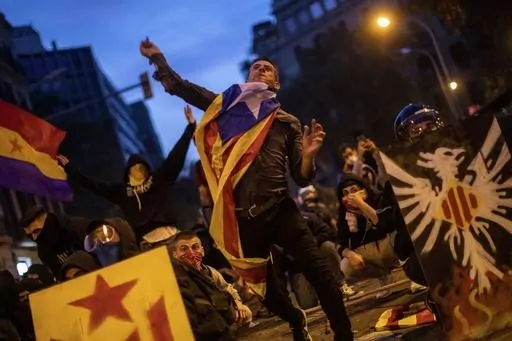 A Catalan pro-independence protestor throws a stone during clashes with police in Barcelona, Spain, Friday, Oct. 18, 2019. Thousands of ordinary citizens got into legal trouble for their parts in Catalonia’s illegal independence bid that brought Spain to the brink of rupture six years ago. Now they are hoping to be saved. Spain’s acting prime minister, Pedro Sánchez, is negotiating with Catalan separatist parties on the possibility of issuing a sweeping amnesty for the separatists in exchan