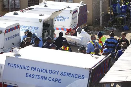 A body is removed from a nightclub where 21 teenagers died in the early hours of the morning, in East London, South Africa, Sunday June 26, 2022. The toxic chemical methanol has been identified as a possible cause of the deaths of 21 teenagers at a bar in the South African city of East London last month, authorities said at press conference in East London Tuesday. July 19, 2022.  (AP Photo/File)