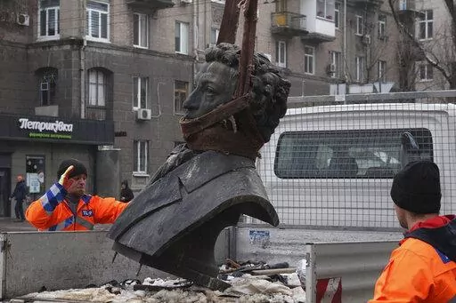 In this photo released by the Dnipro Region Administration, Municipal workers dismantle a monument of Russian writer Alexander Pushkin in the city centre of Dnipro, Ukraine, Friday, Dec. 16, 2022. Ukraine is accelerating efforts to erase the vestiges of centuries of Soviet and Russian influence from the public space by pulling down monuments and renaming hundreds of streets to honor home-grown artists, poets, military chiefs, and independence leaders, even heroes of this year's war. (Dnipro Regi