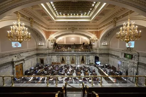 Lawmakers meet on the Senate floor on March 10, 2022, at the Capitol in Olympia, Wash. A bill written to protect young people seeking reproductive health services or gender-affirming care that was widely misrepresented online passed the Democrat-controlled Washington legislature Wednesday, April 19, 2023. (AP Photo/Ted S. Warren, File)