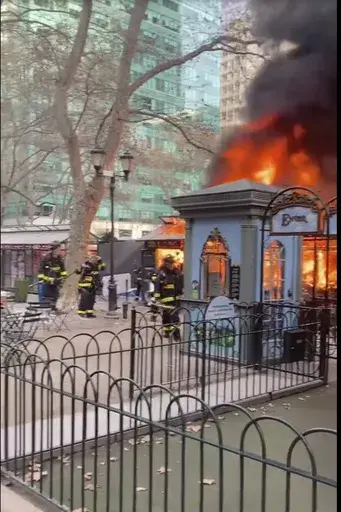 In this image taken from video provided by Eugene McGuire , FDNY respond to a fire at an outdoor holiday market in Bryant Park on Friday, Dec. 27, 2024 in New York. (Eugene McGuire via AP)