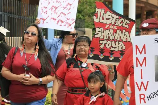 Geraldine Toya, center, marches to bring awareness to the death of her daughter Shawna Toya, in 2021, as dozens of people participate in Missing and Murdered Indigenous Persons Awareness Day in Albuquerque, N.M., Sunday, May 5, 2024. (AP Photo/Susan Montoya Bryan)