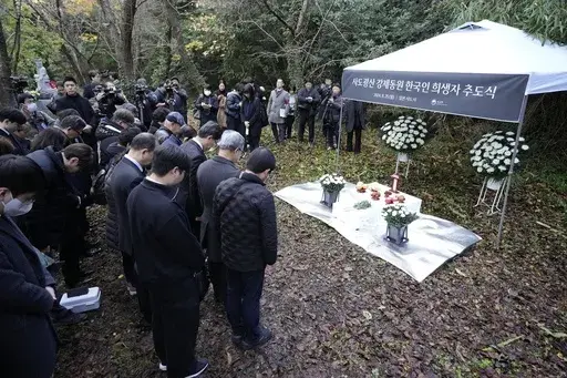 Relatives of Korean victims and South Korean officials offer a minute of silence during a memorial service in Sado, Niigata prefecture, Japan, Monday, Nov. 25, 2024, a day after boycotting a memorial organized by Japanese officials. (AP Photo/Eugene Hoshiko)